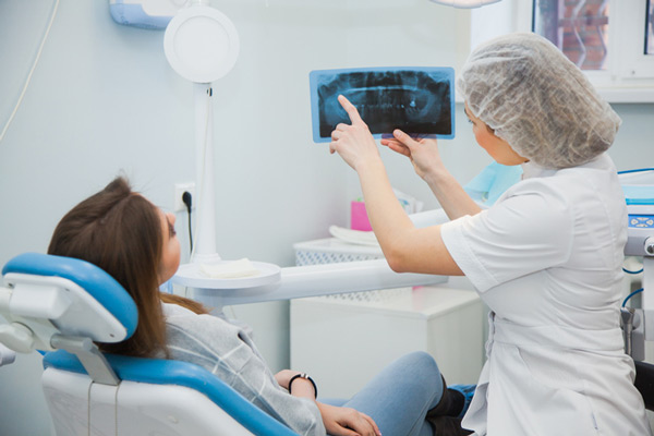 Patient being shown her X-ray at Surf City Oral and Maxillofacial Surgery in Huntington Beach, CA