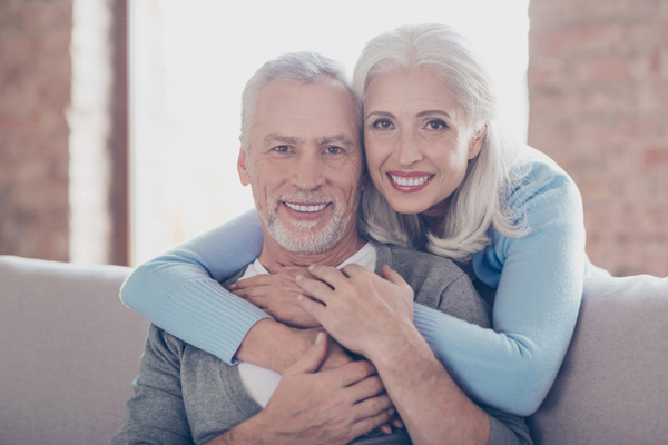 older couple smiling after learning about the longevity of the all-on-4 treatment concept from Surf City Oral and Maxillofacial Surgery in Huntington Beach, CA