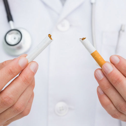 Dr. breaking cigaret to get patient to quit smoking 