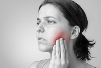 Woman with sore wisdom tooth